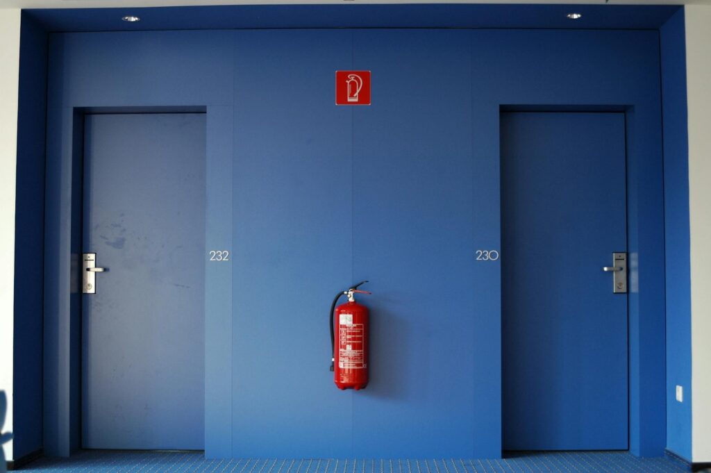 blue doors with fire extinguisher in corridor
