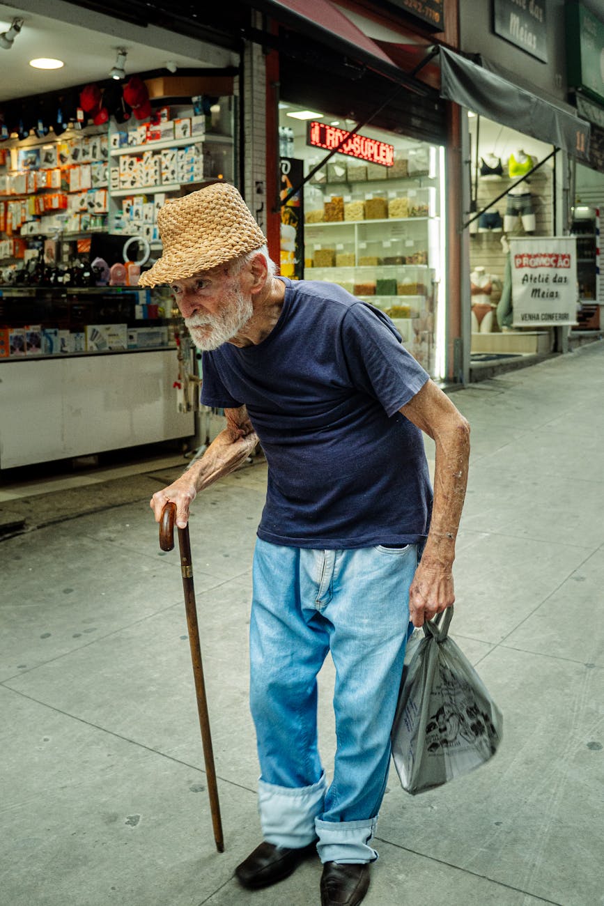 elderly man walking in city street market