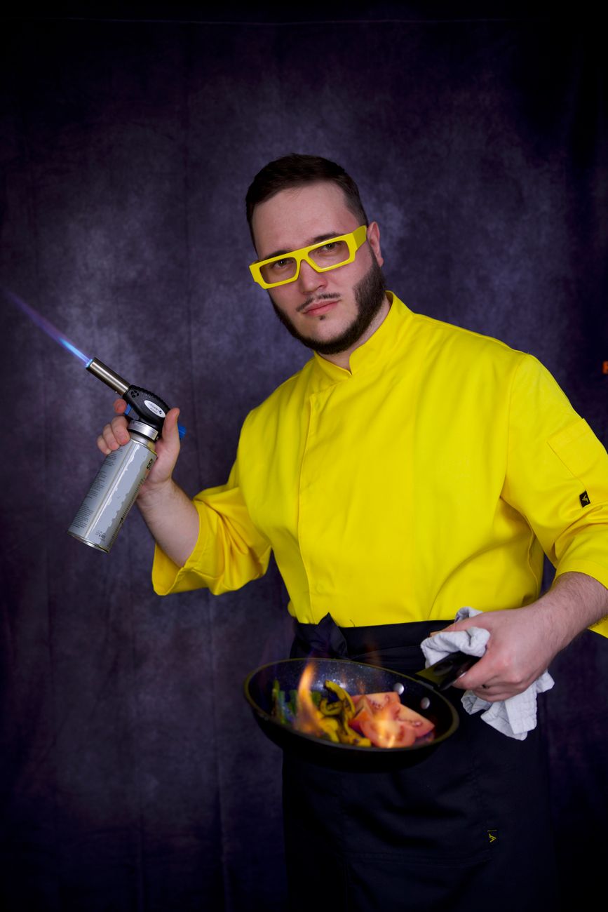 man cooking with a blowtorch